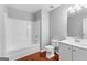 Bright bathroom features a shower-tub combo, white fixtures, and wood-look floors at 4506 White Rd, Douglasville, GA 30135