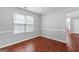 Bedroom boasts hardwood-style floors and a window, creating a bright, inviting space at 4506 White Rd, Douglasville, GA 30135