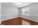 Bedroom features wood-look flooring, neutral paint, and natural light from the window at 4506 White Rd, Douglasville, GA 30135