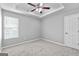 Carpeted bedroom with tray ceiling, ceiling fan, and one window at 4506 White Rd, Douglasville, GA 30135