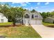 Two-story home featuring a well-manicured lawn, two-car garage, and a welcoming entrance at 4506 White Rd, Douglasville, GA 30135