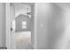 Hallway with neutral walls and carpet leads to an open bedroom with ceiling fan at 4506 White Rd, Douglasville, GA 30135