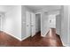 Hallway with multiple doors, wood-look flooring, and access to other rooms in the home at 4506 White Rd, Douglasville, GA 30135