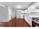 Open kitchen features white cabinets, laminate countertops and stainless steel appliances at 4506 White Rd, Douglasville, GA 30135