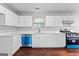 Bright kitchen showcasing white cabinets, laminate countertops, and modern stainless steel appliances at 4506 White Rd, Douglasville, GA 30135