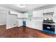 Bright kitchen featuring white cabinetry, stainless steel appliances, and wood floors at 4506 White Rd, Douglasville, GA 30135