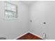 Laundry area with utility connections, natural light, and durable wood-look flooring at 4506 White Rd, Douglasville, GA 30135