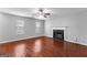 Living room featuring a fireplace, hardwood floors, ceiling fan, and a sunlit window at 4506 White Rd, Douglasville, GA 30135