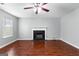 Spacious living room featuring a fireplace, fan, and hardwood floors at 4506 White Rd, Douglasville, GA 30135