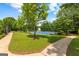 Well-maintained blue tennis court with lush green surroundings in a beautiful, serene community setting at 4506 White Rd, Douglasville, GA 30135