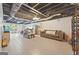 Finished basement with tiled floor, seating area, and exposed ceiling at 6645 N Glen Dr, Cumming, GA 30028