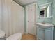 Bathroom boasts vintage vanity and shower with gold detail curtain at 6645 N Glen Dr, Cumming, GA 30028