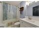 Full bath with white vanity and shower-tub combination at 6645 N Glen Dr, Cumming, GA 30028