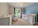 Bright bedroom with plush carpet, white furniture and ample natural light at 6645 N Glen Dr, Cumming, GA 30028