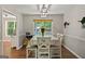 Cozy dining room with a large window, and a classic chandelier at 6645 N Glen Dr, Cumming, GA 30028