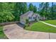 Side view of a home with a long driveway leading to a two-car garage at 6645 N Glen Dr, Cumming, GA 30028