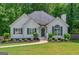 Charming single-story home featuring a well-manicured lawn and inviting entryway at 6645 N Glen Dr, Cumming, GA 30028