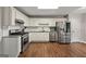 Modern kitchen with stainless steel appliances, white cabinets, and subway tile backsplash at 6645 N Glen Dr, Cumming, GA 30028