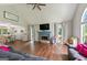 Open-concept living room showcasing hardwood floors, a fireplace, and dining area at 6645 N Glen Dr, Cumming, GA 30028