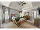 Serene main bedroom with tray ceilings, a large bed, and neutral decor at 6645 N Glen Dr, Cumming, GA 30028