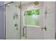 Luxurious shower showcases dual shower heads, white tile, and glass enclosure at 6645 N Glen Dr, Cumming, GA 30028
