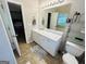 Well-lit bathroom with a white vanity, large mirror, and open doorway at 110 Shelby Oaks Trl, Covington, GA 30016