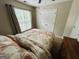 Comfortable bedroom featuring a large window with blinds and soft bedding at 110 Shelby Oaks Trl, Covington, GA 30016
