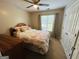 Cozy bedroom featuring a ceiling fan and a comfortable bed with patterned bedding at 110 Shelby Oaks Trl, Covington, GA 30016