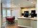 Open dining room with tile floor, and centered with an elegant chandelier and table setting for six at 110 Shelby Oaks Trl, Covington, GA 30016