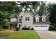 Charming two-story home with a two car garage, manicured lawn, and traditional architectural details at 110 Shelby Oaks Trl, Covington, GA 30016