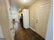 Hallway showing refrigerator, backdoor, and dining room with tiled floor at 110 Shelby Oaks Trl, Covington, GA 30016