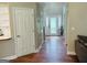 Inviting hallway with wood flooring and a view of the decorative glass front door at 110 Shelby Oaks Trl, Covington, GA 30016