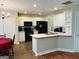 Well-equipped kitchen with black appliances, white cabinets, and bar seating at 110 Shelby Oaks Trl, Covington, GA 30016
