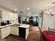 Open kitchen flows into living room with white cabinets and tile flooring at 110 Shelby Oaks Trl, Covington, GA 30016