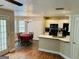 Bright kitchen featuring white cabinets, black appliances, and a breakfast bar overlooking the dining area at 110 Shelby Oaks Trl, Covington, GA 30016