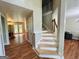 Traditional staircase with wood railings and a view of the living room at 110 Shelby Oaks Trl, Covington, GA 30016