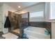 Beautiful bathroom showcasing a tiled shower and a soaking tub under a window at 4752 Albany Way, South Fulton, GA 30331