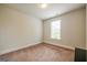 Cozy carpeted bedroom with a bright window and fresh neutral paint at 4752 Albany Way, South Fulton, GA 30331