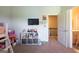 Bright bedroom with storage unit, TV, and doorway leading to an upper level at 4752 Albany Way, South Fulton, GA 30331