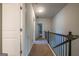 Hallway with carpet and railing and neutral-toned walls at 4752 Albany Way, South Fulton, GA 30331