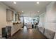 Open-concept kitchen featuring gray cabinets, granite counters, and a large island with bar seating with view to living area at 4752 Albany Way, South Fulton, GA 30331