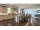 Spacious kitchen features a large island, stylish pendant lights, and stainless steel appliances, open to a living area at 4752 Albany Way, South Fulton, GA 30331