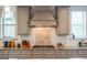 Close-up of the kitchen featuring a stylish backsplash, granite countertops, and stainless steel gas range at 4752 Albany Way, South Fulton, GA 30331