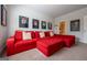 Spacious living room with a comfortable red sofa, sports memorabilia, and a doorway to the bathroom at 4752 Albany Way, South Fulton, GA 30331