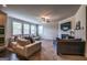 Inviting living room with plush sofas, a ceiling fan, and a fireplace below a mounted flatscreen TV at 4752 Albany Way, South Fulton, GA 30331
