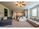 Open concept living room with view to kitchen and dining area, featuring multiple couches and natural light at 4752 Albany Way, South Fulton, GA 30331