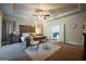 Inviting primary bedroom featuring a luxurious bed, seating area, and ensuite bathroom at 4752 Albany Way, South Fulton, GA 30331