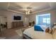 Relaxing primary bedroom showcasing a TV, sitting area, and tray ceiling at 4752 Albany Way, South Fulton, GA 30331