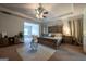 Spacious primary bedroom featuring a tray ceiling, seating area and a king-sized bed at 4752 Albany Way, South Fulton, GA 30331