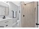 Modern bathroom with walk-in shower, stylish vanity, and a sleek mirror at 786 Neal Nw St, Atlanta, GA 30318